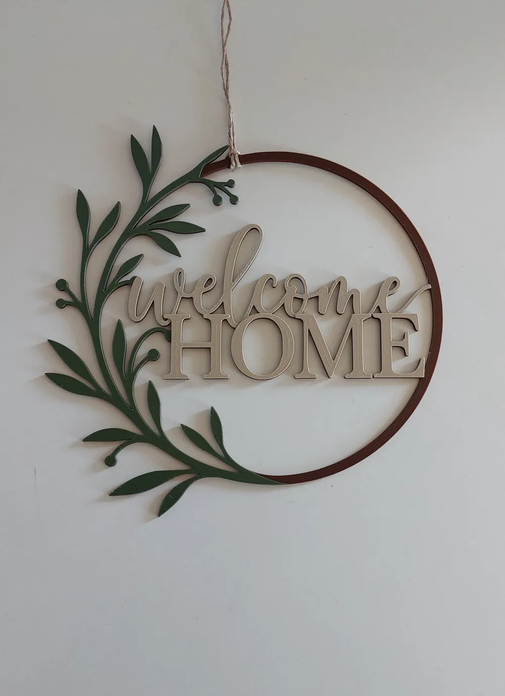 Close-up of Welcome Home 3D printed wall art sign showing minimalist typography and depth